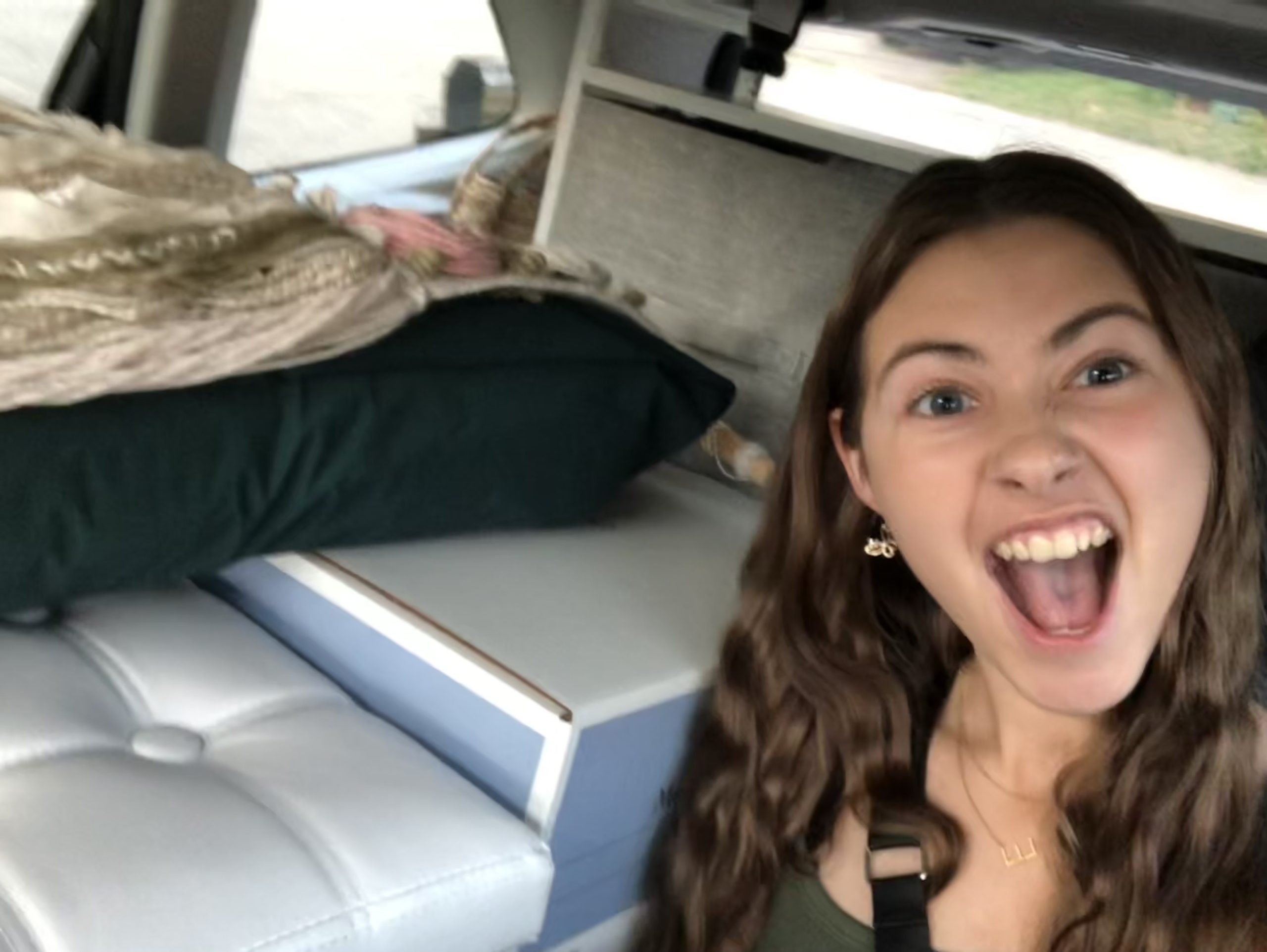 girl in packed car with excited face