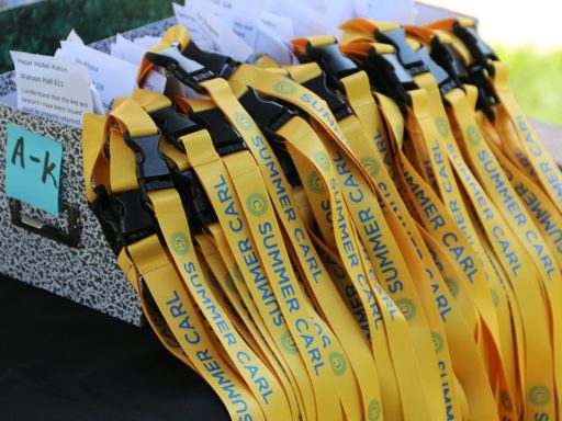 Many yellow lanyards that say 