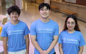 Three Summer Employees Standing and Smiling in SLAI Shirts