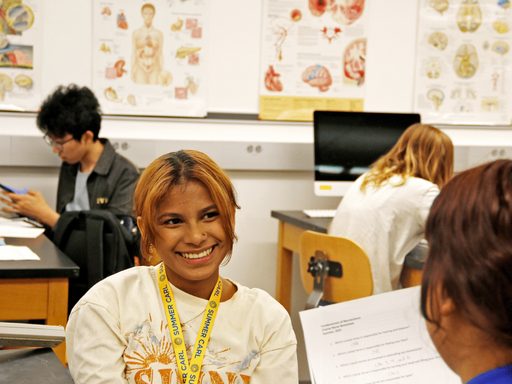 A Summer Carl sitting and smiling in a classroom.