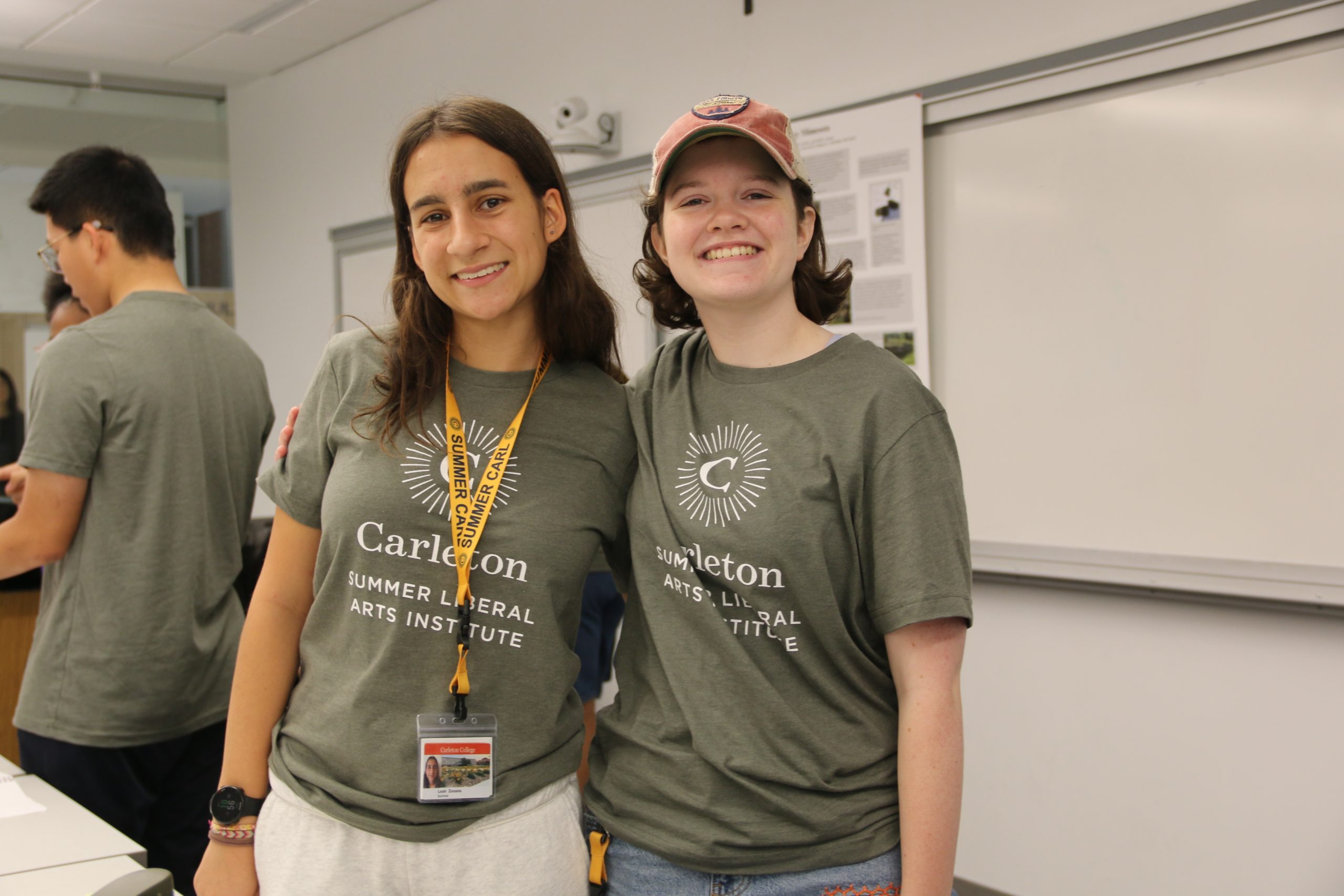 Two STEM in the Field stuents stand smiling and looking into the camera