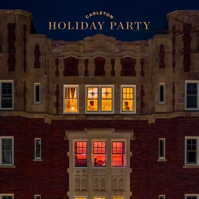 Nighttime photo of Burton Hall with lights in the windows