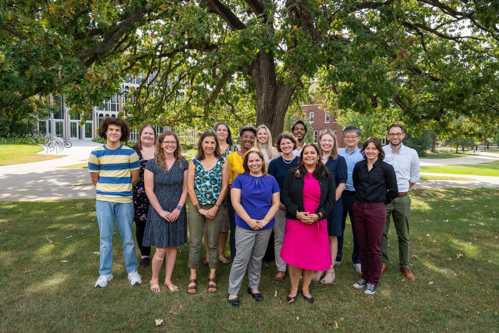 Group of people smiling under a tree