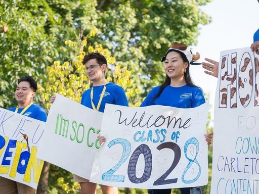 students with welcome signs