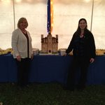 Cake replica of Willis Hall with General Manager, Katie McKenna, and Board Manager, Jenny Pope