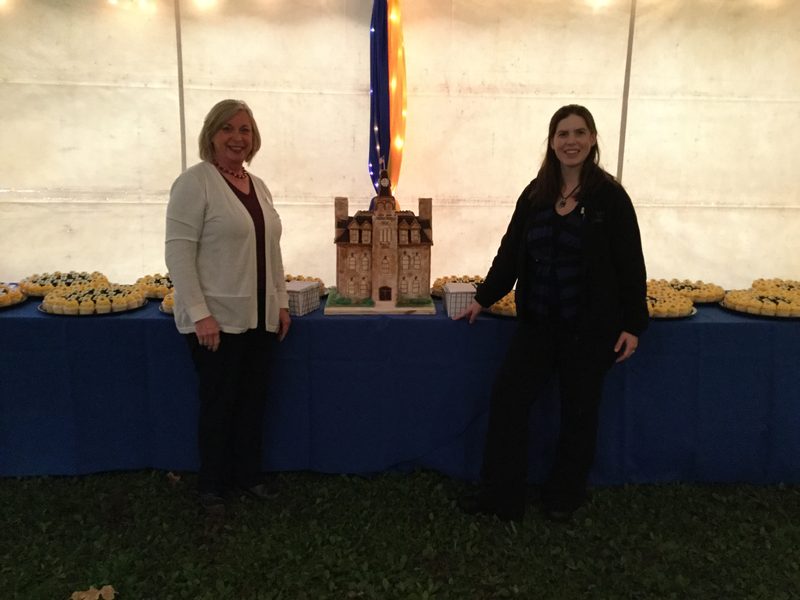 Cake replica of Willis Hall with General Manager, Katie McKenna, and Board Manager, Jenny Pope
