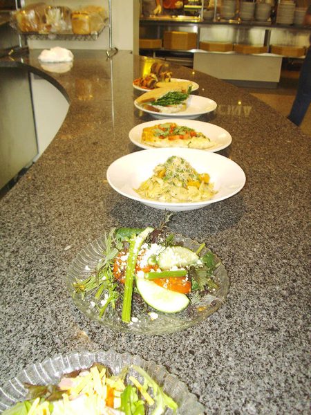 An array of salad plates, all with locally grown ingredients