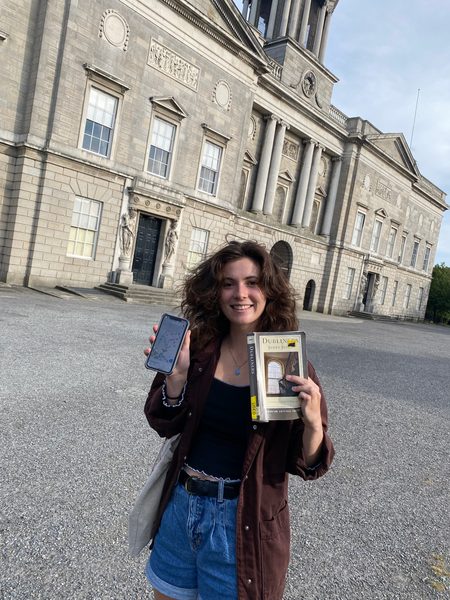Hannah holding up a map from Mapping Dubliners and also her copy of Dubliners