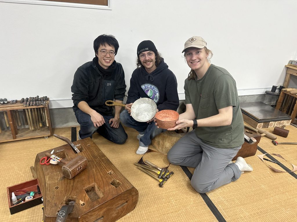 3 people holding pans