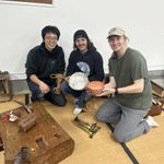 researchers kneeling with pan