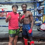 Researcher poses with person at a boxing gym