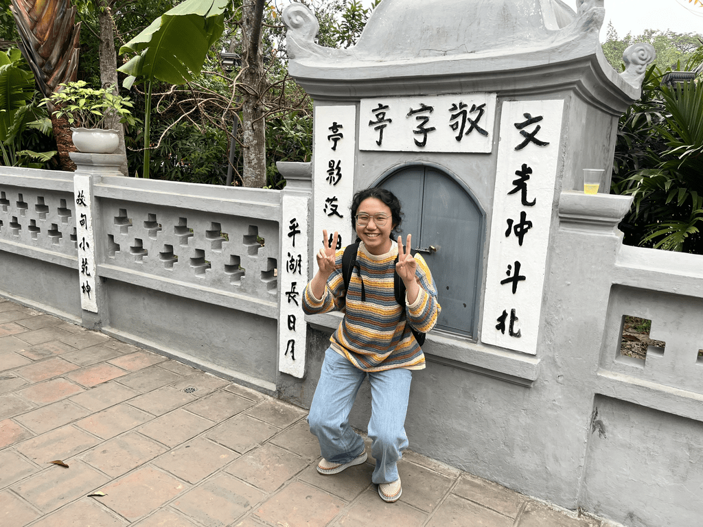 student in front of building