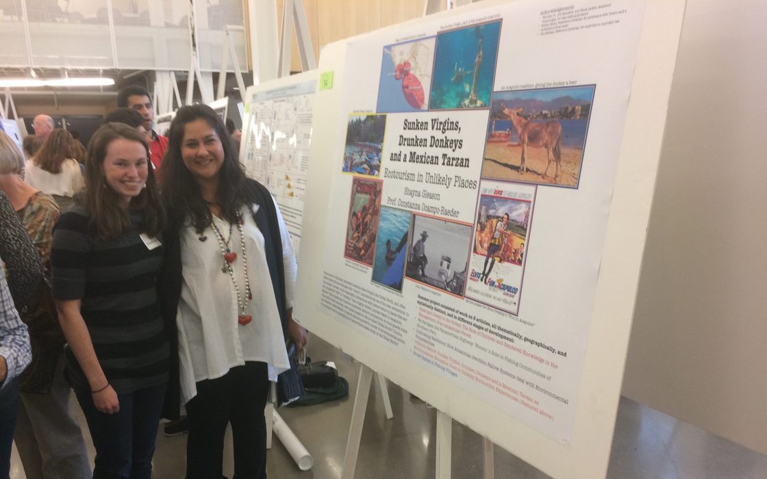 A student and professor at a poster presentation