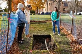 Students showing excavation hole