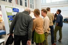 People looking at event poster