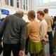 People looking at event poster