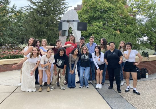 New Writing Consultants gathered around the statue outside of Gould Library