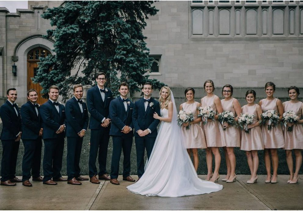 wedding party pose for photo outside skinner chapel