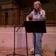 Carleton singing with guitar at National Coming Out Day Service