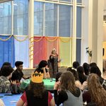 Rabbi Shosh Dworsky speaking to the crowd of students seated at tables