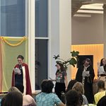 Students in Purim costumes in front of the crowd of students at Holi Purim