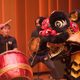 Black lion dancer with drum