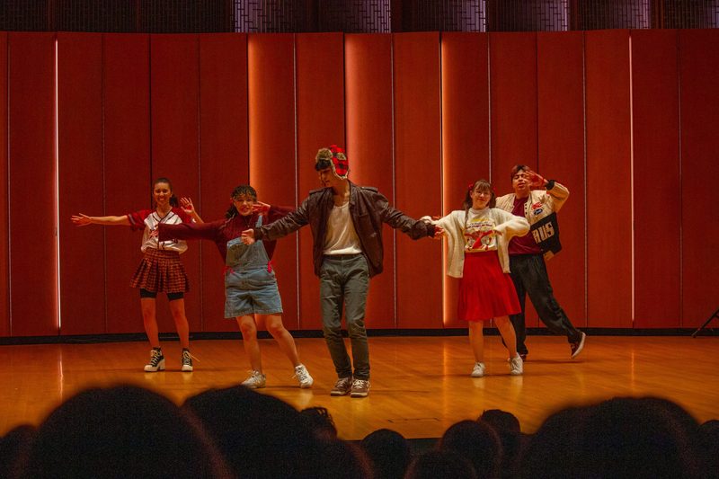 Five students on stage dancing