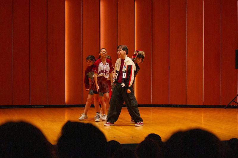 Group of four students performing on stage in Kracum