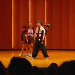 Group of four students performing on stage in Kracum
