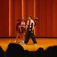 Group of four students performing on stage in Kracum