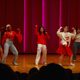 Three students on stage dancing
