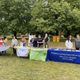 Students and staff at a NSW tabling event on the bald spot. 4 tables with signs that include the Office of the Chaplain, Carleton Druids and Episcopal Student Association
