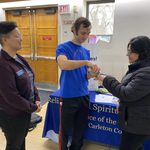 A student imposing ashes on a staff member's hand in Sayles