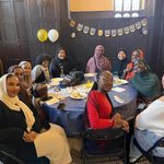 Group of students gathered at a table at Eid celebration 2024