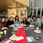 Group of students sitting at a table at the Knightly Iftar