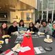 Group of students sitting at a table at the Knightly Iftar