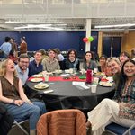 Group of students sitting at a table at the Knightly Iftar