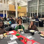 Group of students sitting at a table at the Knightly Iftar