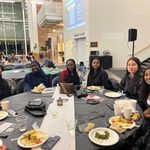 Group of students sitting at a table at the Knightly Iftar