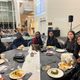 Group of students sitting at a table at the Knightly Iftar