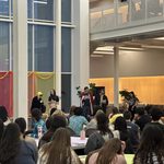 Group of students in costumes speaking at Holi/Purim