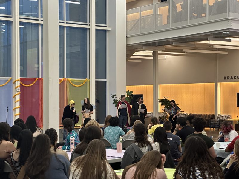 Group of students in costumes speaking at Holi/Purim