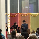 Two students speaking at Holi/Purim