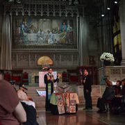 Rev. Schuyler Vogel, College Chaplain, in the front of the Unitarian Universalist sanctuary in New York. Behind him is the mosaic of Jesus washing the disciples feet.