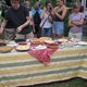 Jacob cuts the pies for eating.
