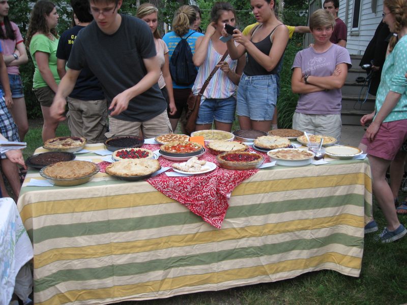 Jacob cuts the pies for eating.