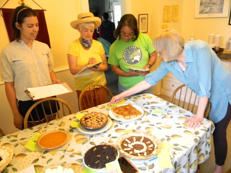 The judges (Bia, Jean and Carolyn) carefully evaluate each pie under Julia's careful supervision.