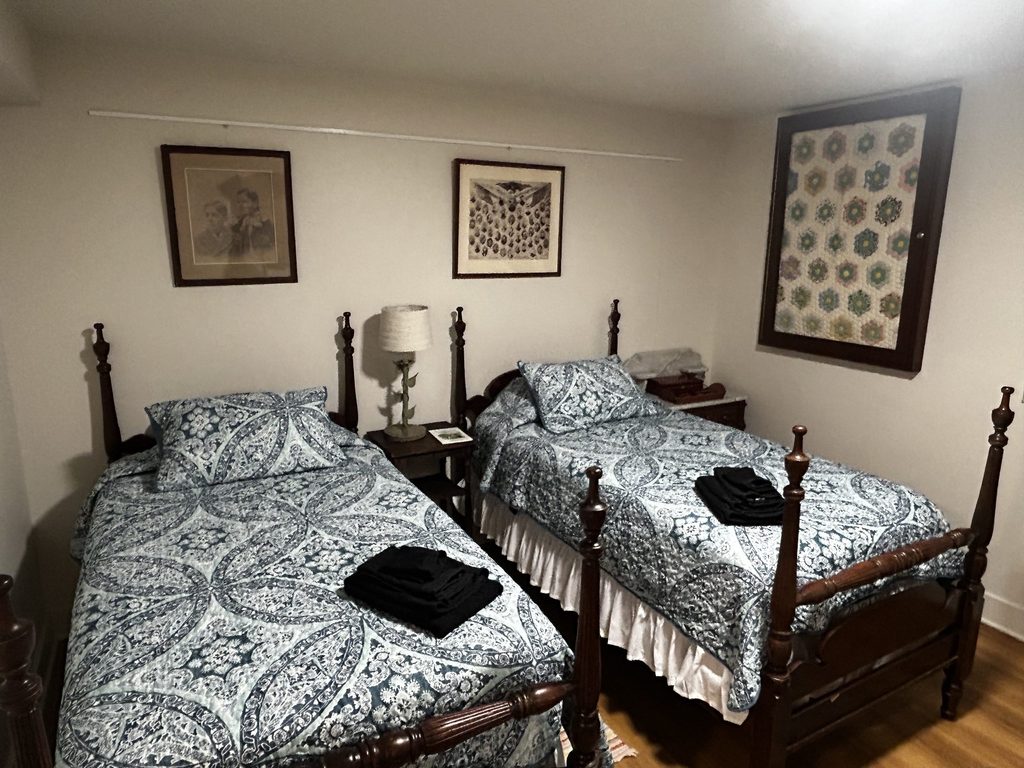 two twin beds with set of towels at the end