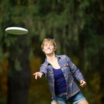 A student tosses a frisbee
