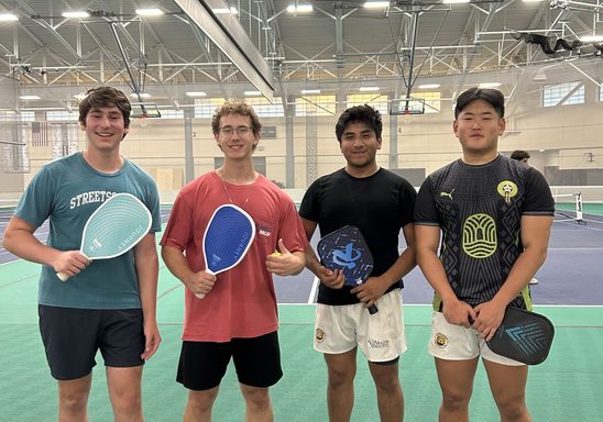 Four pickleball players in the fieldhouse